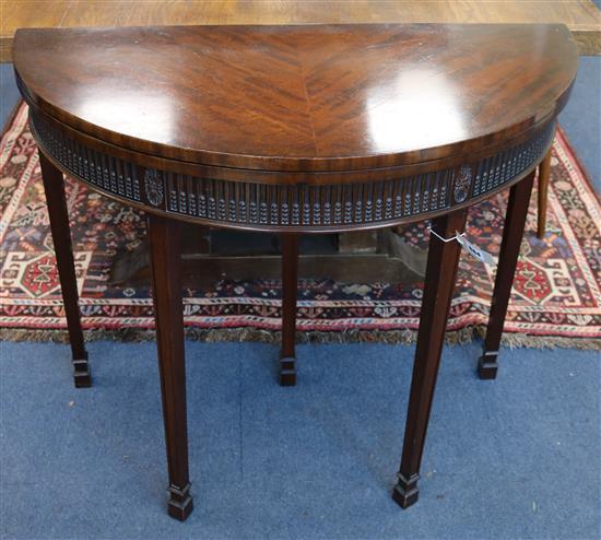 A mahogany folding demi-lune card table W.92cm